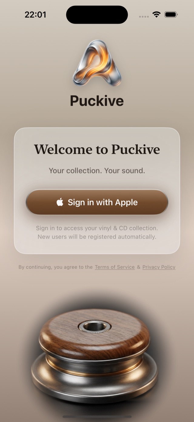 Puckive's actual sign-in screen, showing the Sign in with Apple button and the walnut-and-brass hero image